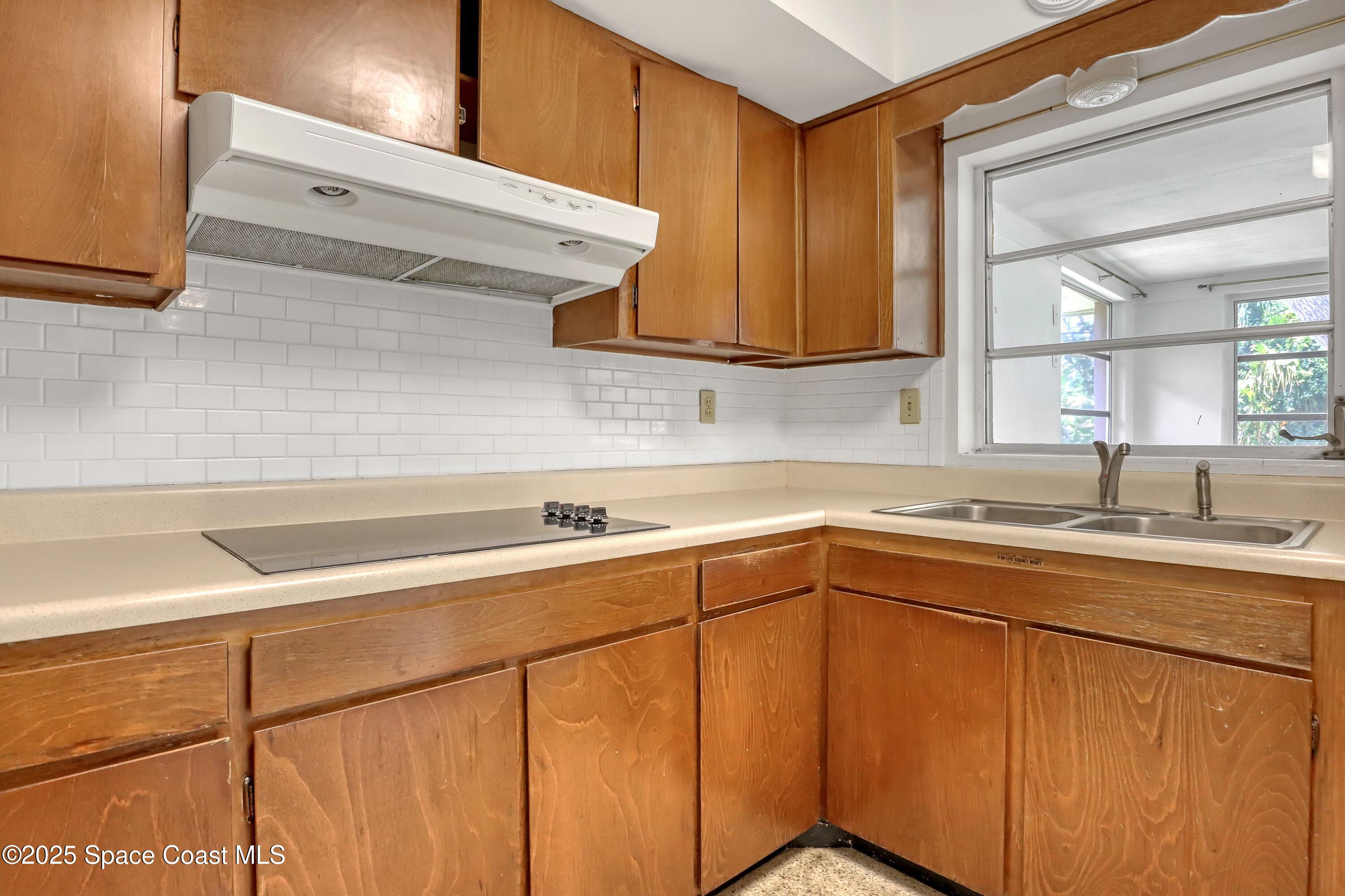 955 Samar Road Cocoa Beach, FL 32931 - Photo 20 of 37 a kitchen with a sink cabinets and appliances