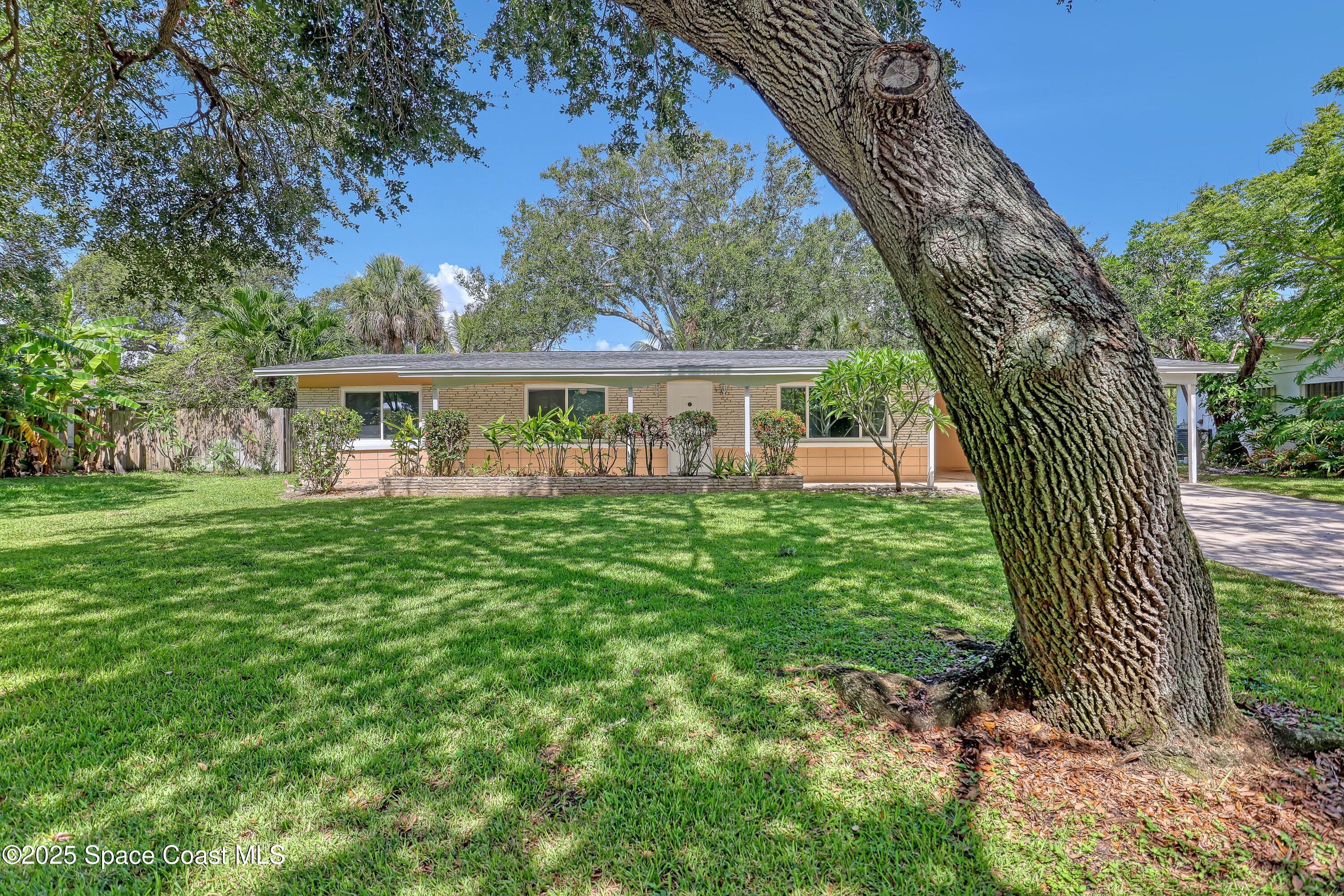 955 Samar Road Cocoa Beach, FL 32931 - Photo 2 of 37 a view of a house with a yard