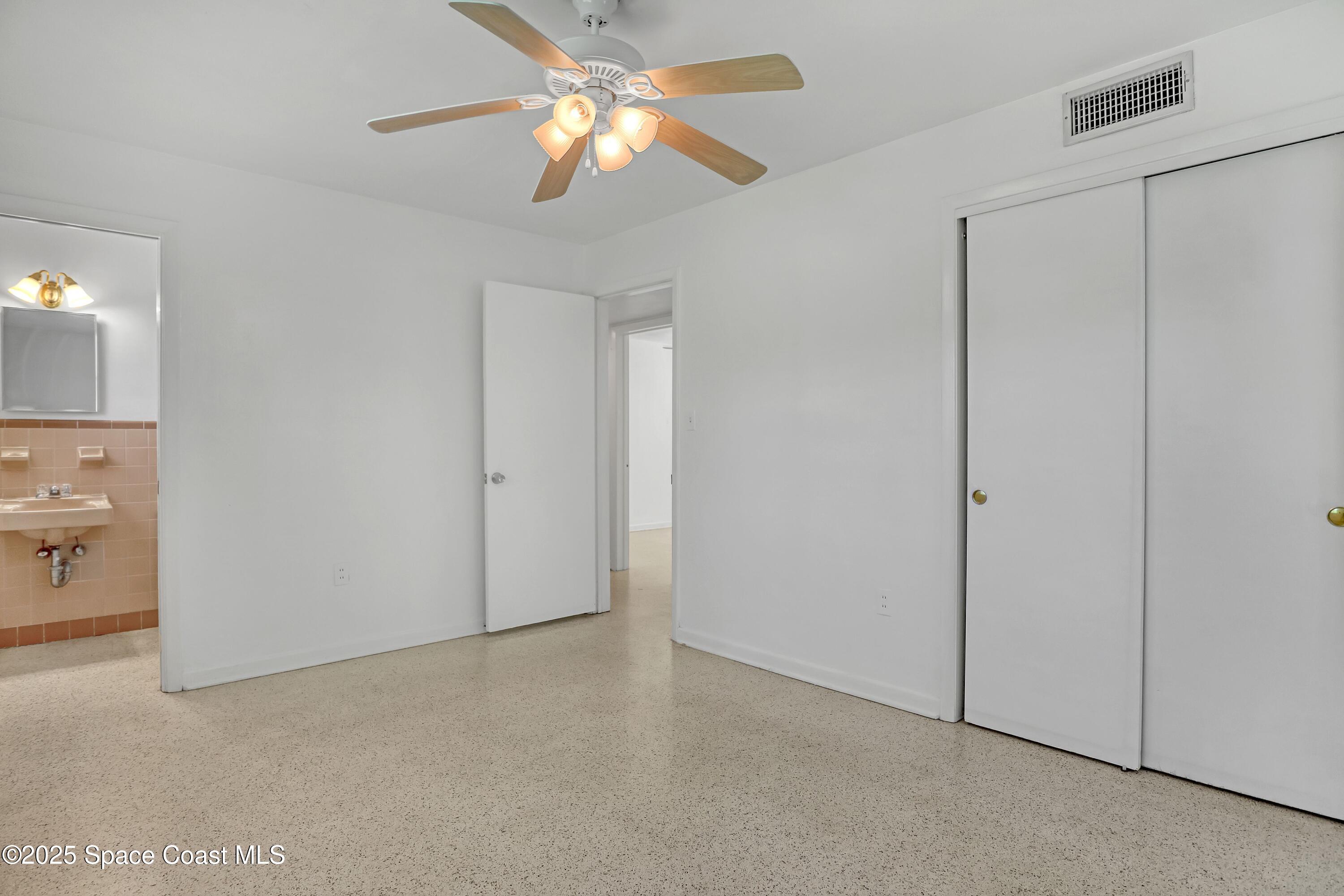 955 Samar Road Cocoa Beach, FL 32931 - Photo 24 of 37 a view of a livingroom with a ceiling fan