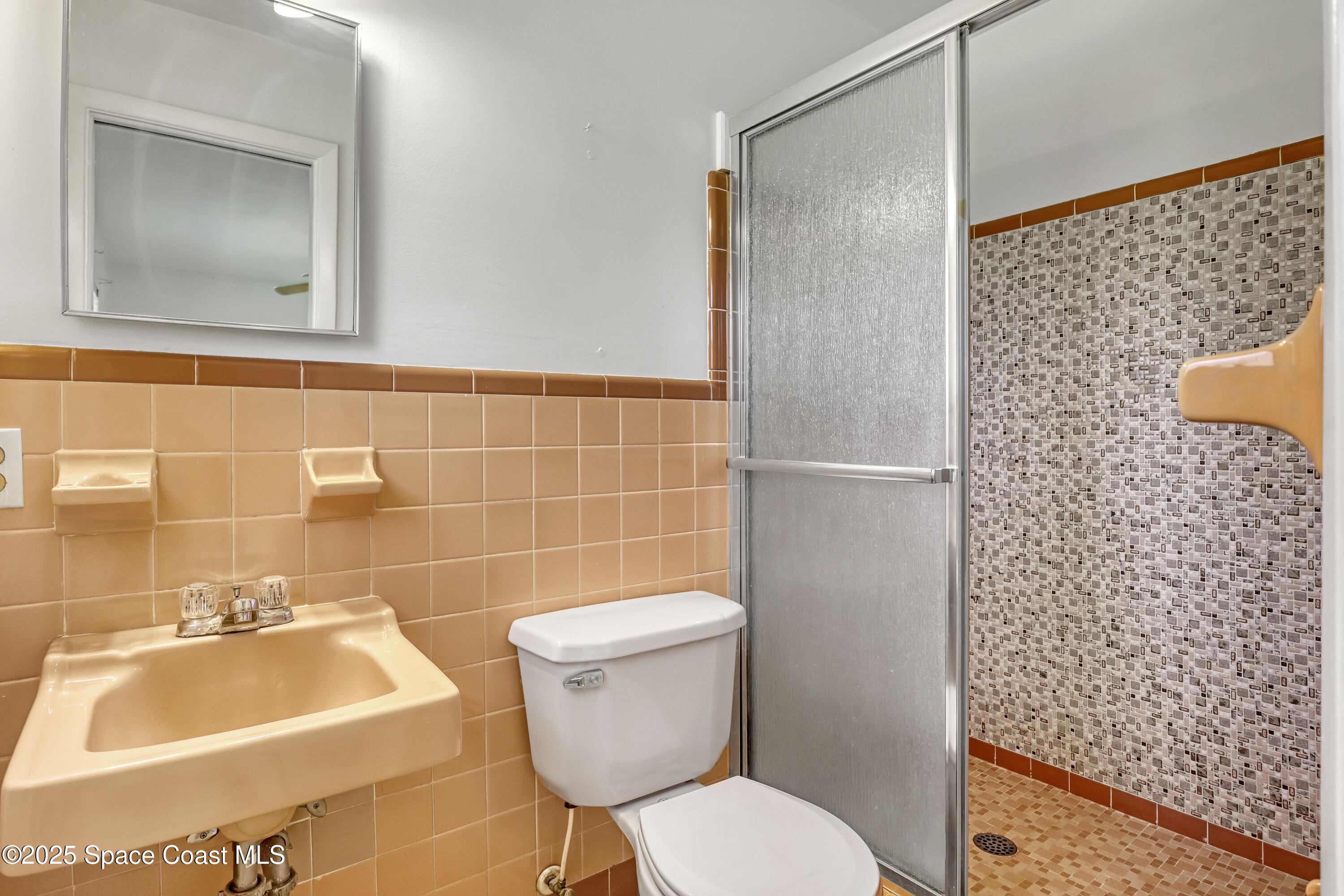 955 Samar Road Cocoa Beach, FL 32931 - Photo 26 of 37 a bathroom with a sink toilet and shower