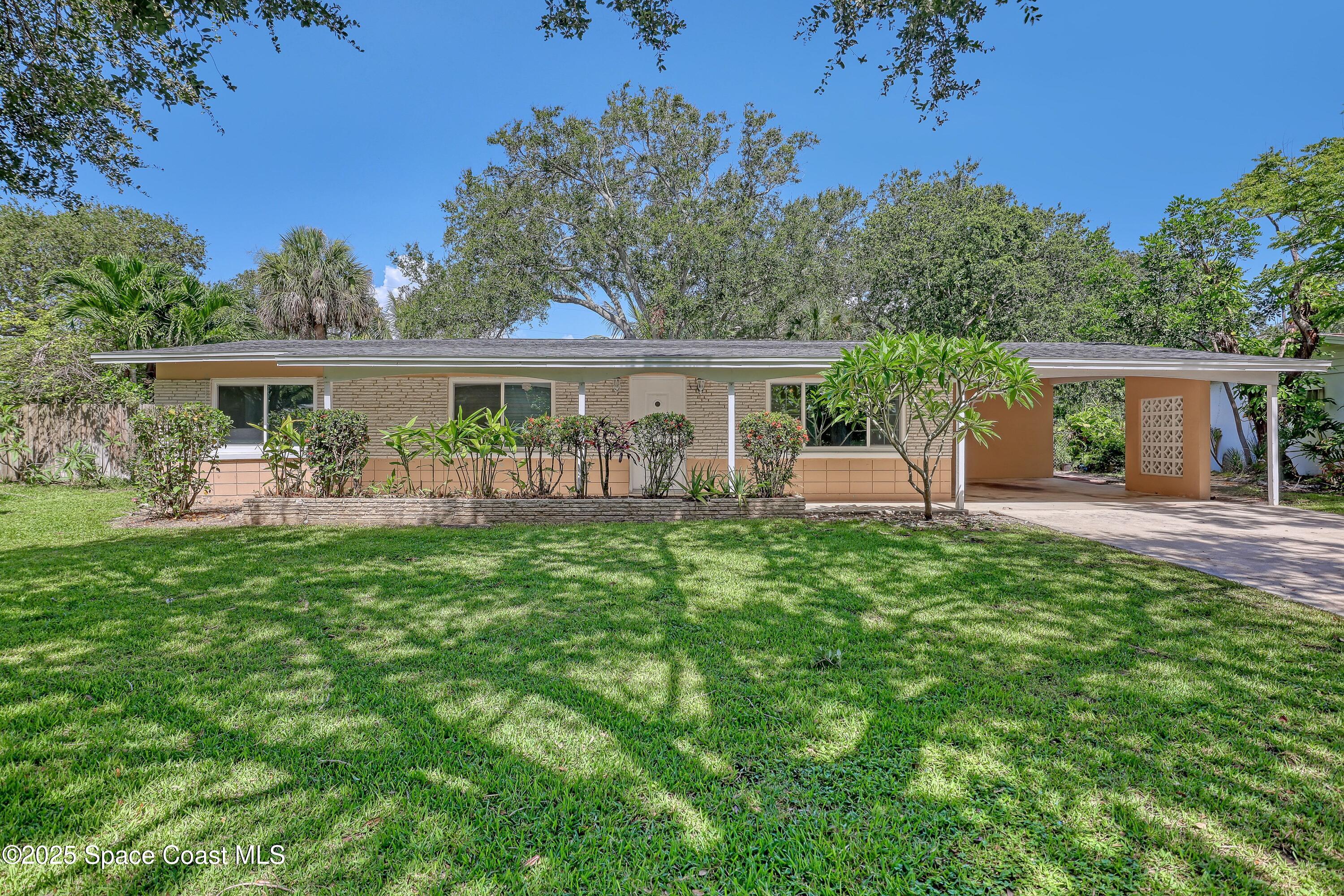 955 Samar Road Cocoa Beach, FL 32931 - Photo 34 of 37 a view of a house with a backyard