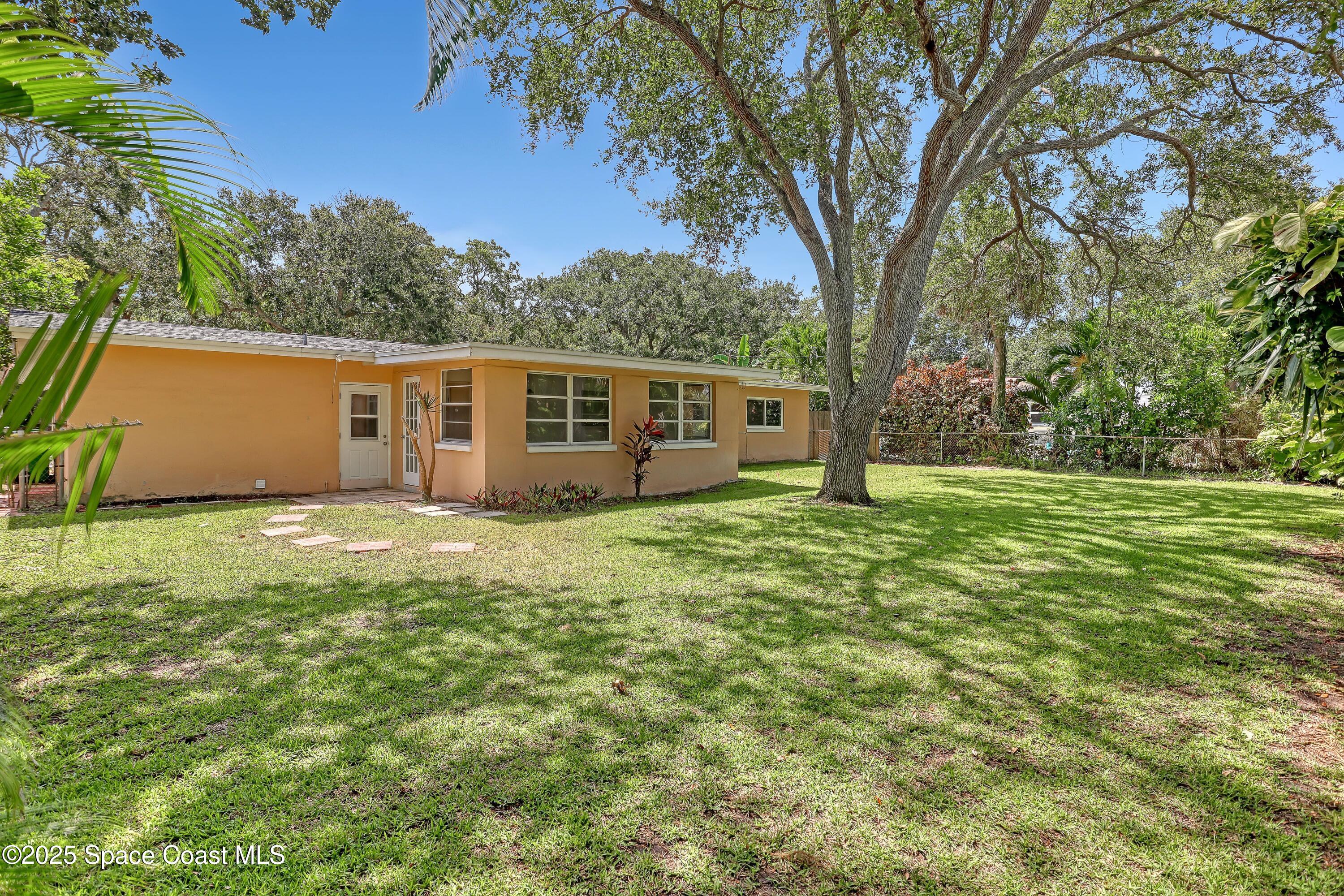 955 Samar Road Cocoa Beach, FL 32931 - Photo 4 of 37 a view of a house with backyard and garden