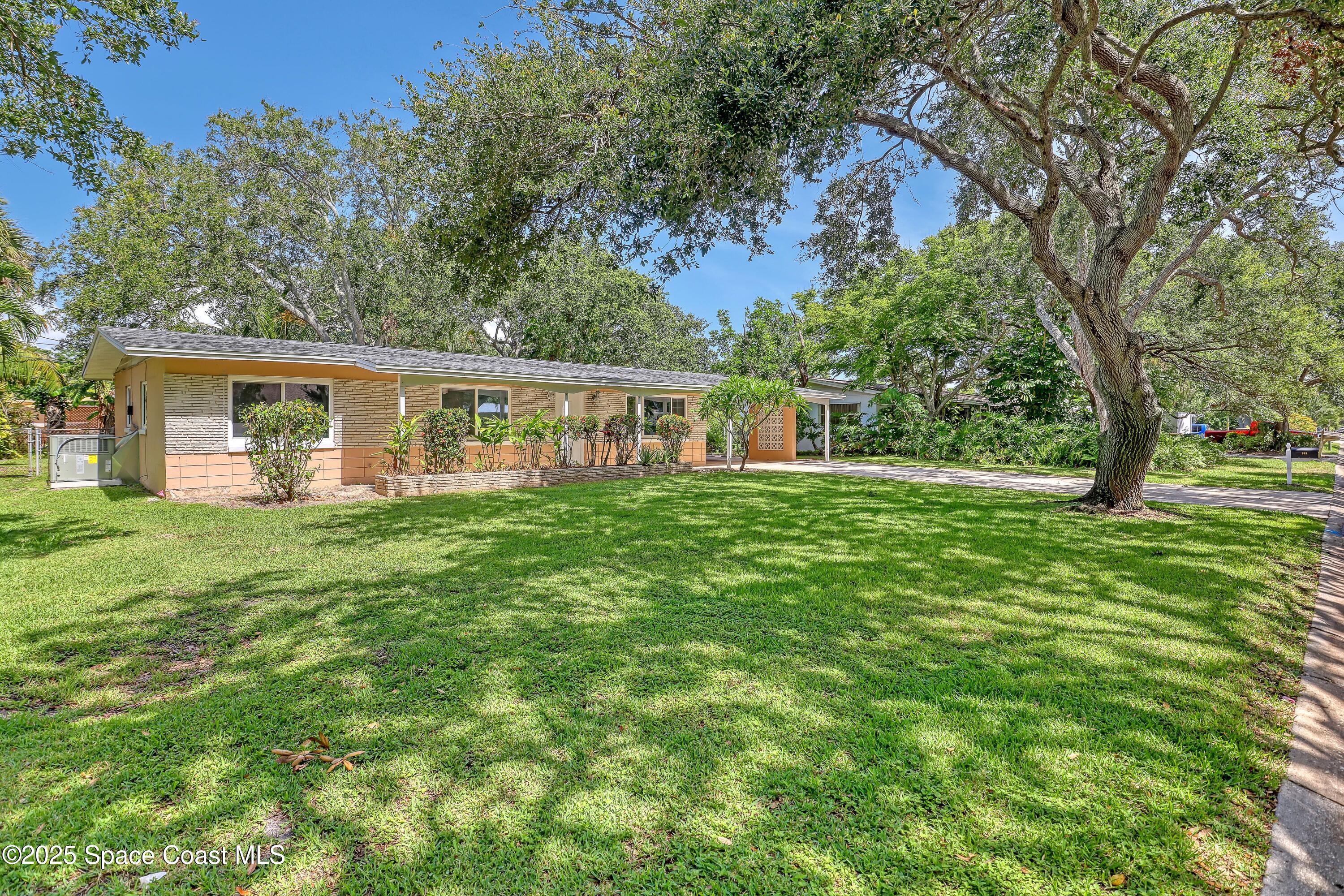955 Samar Road Cocoa Beach, FL 32931 - Photo 7 of 37 a view of a house with a backyard