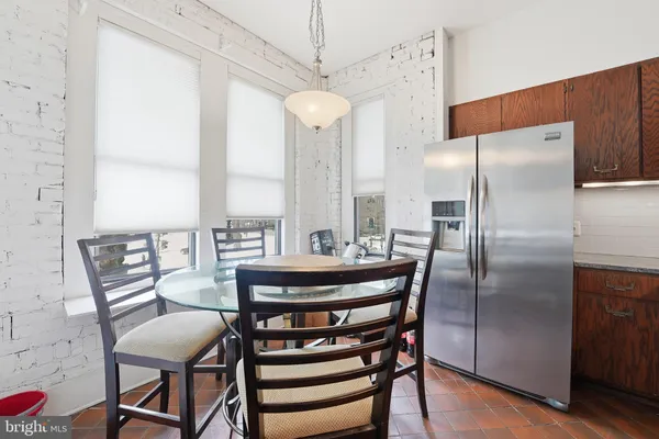 a view of a dining room with furniture a chandelier and wooden floor