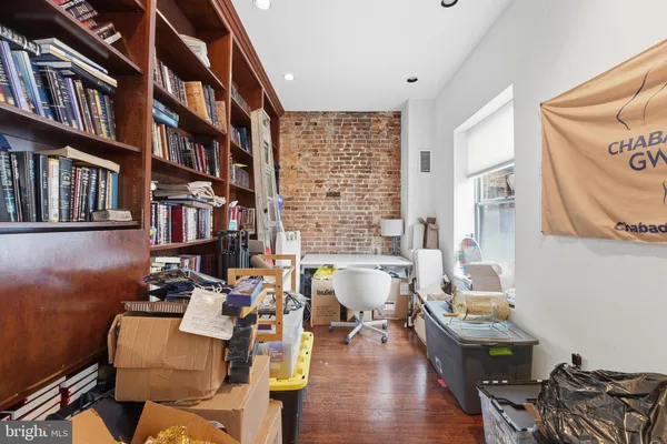 a living room with furniture and book shelf