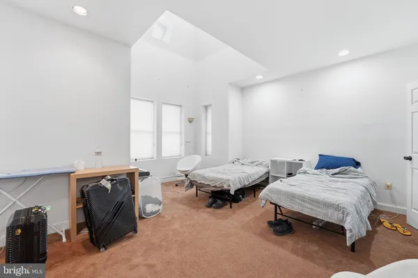 a bedroom with two beds and chair
