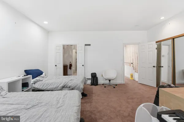 a bedroom with two beds and painted walls