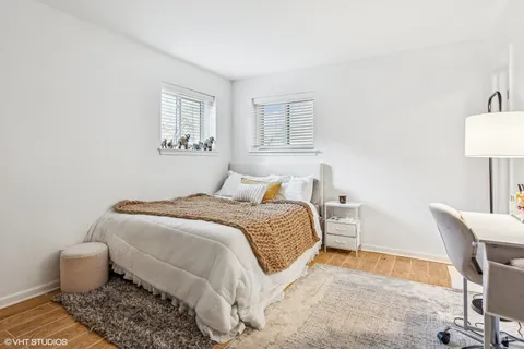 a bedroom with a bed and a chair