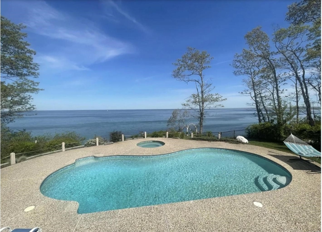 a view of a swimming pool with a yard