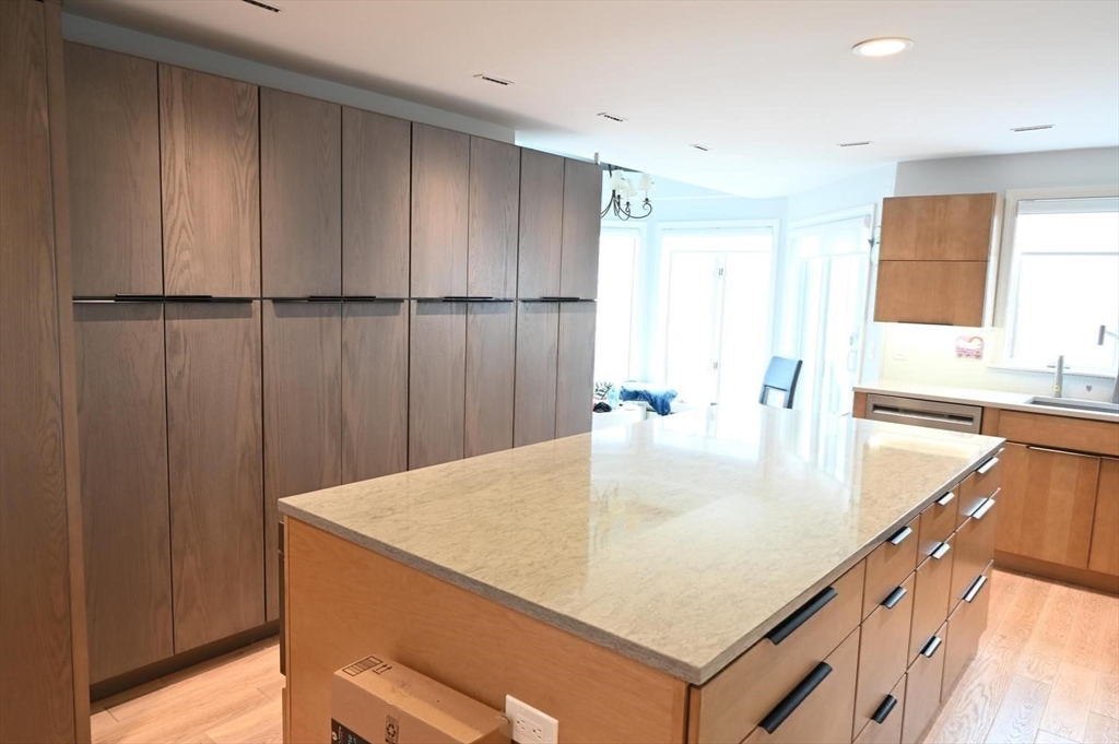 31 Ellisville Road Plymouth, MA 02360 - Photo 13 of 40 a kitchen with kitchen island a sink and wooden cabinets