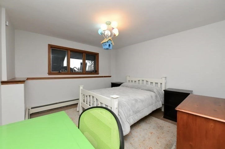 31 Ellisville Road Plymouth, MA 02360 - Photo 29 of 40 a bedroom with a bed and a chandelier