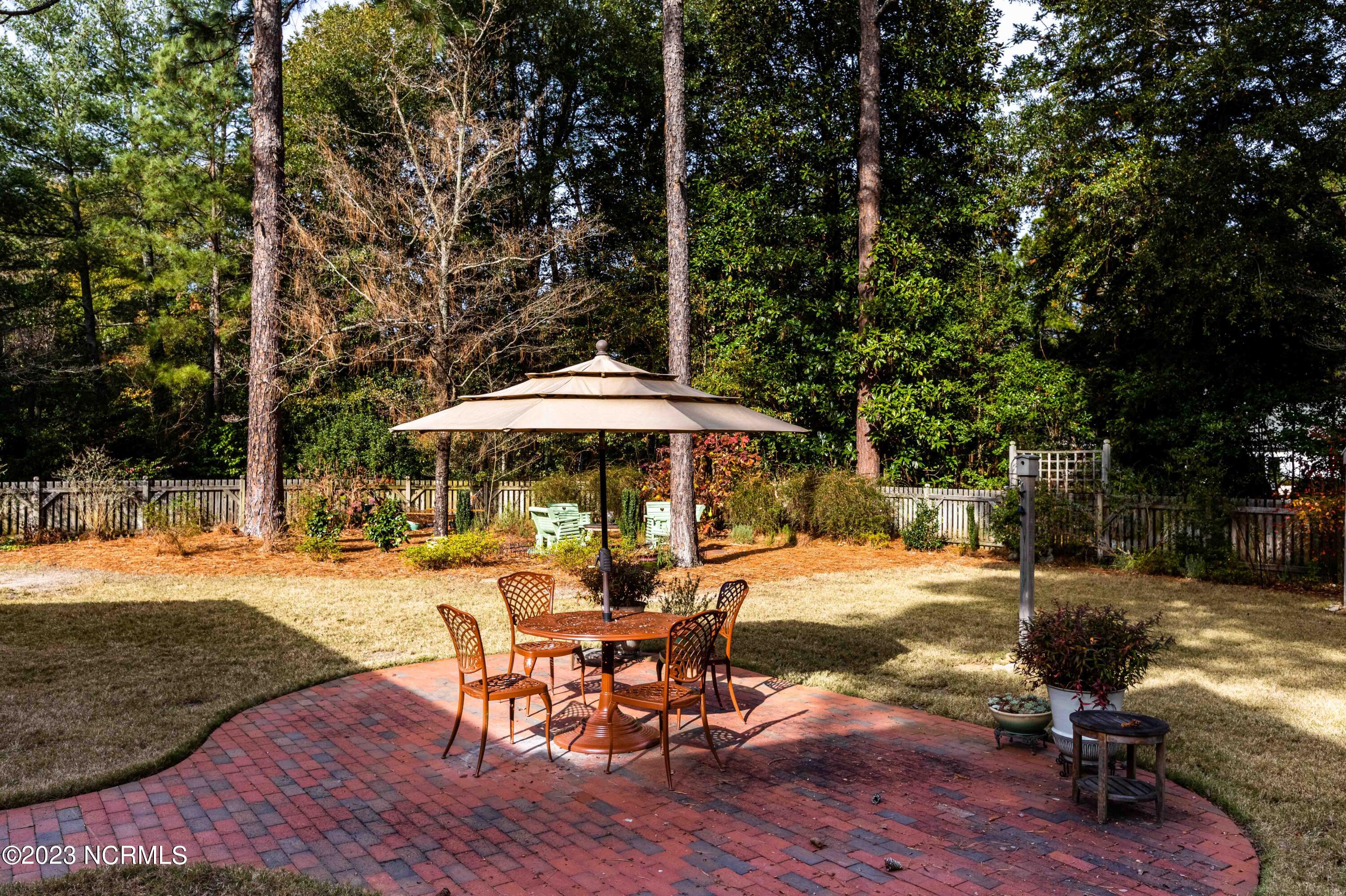 15 Wilson Road Pinehurst, NC 28374 - Photo 28 of 36 Table, Chairs and Umbrella Convey