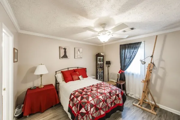 a bedroom with a bed and a chandelier