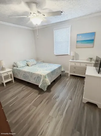 a bedroom with a bed and a wooden floor