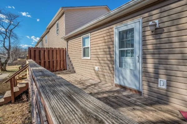 a view of a house with wooden deck