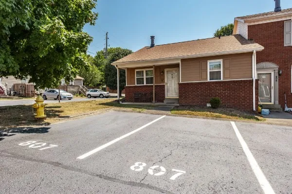 a view of a house with pool and sitting area