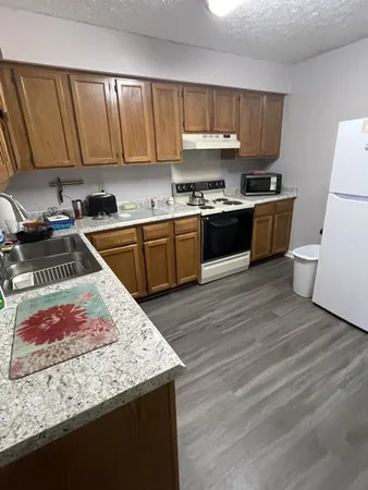 a kitchen with a stove a sink and a refrigerator
