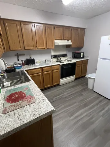a kitchen with a stove a sink and a refrigerator