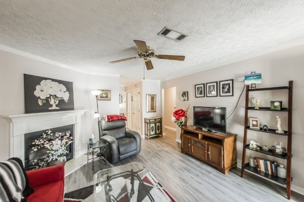 430 Walton Ferry Road, Unit 807 Hendersonville, TN 37075 - Photo 5 of 24 a living room with furniture a flat screen tv and a fireplace