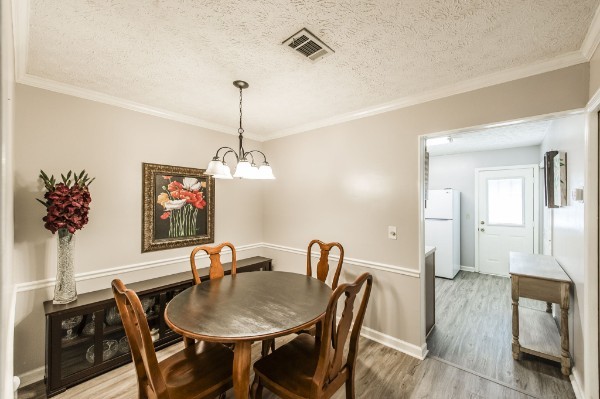 430 Walton Ferry Road, Unit 807 Hendersonville, TN 37075 - Photo 6 of 24 a view of a dining room with furniture wooden floor and a chandelier