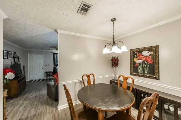 a dining room with furniture and wooden floor