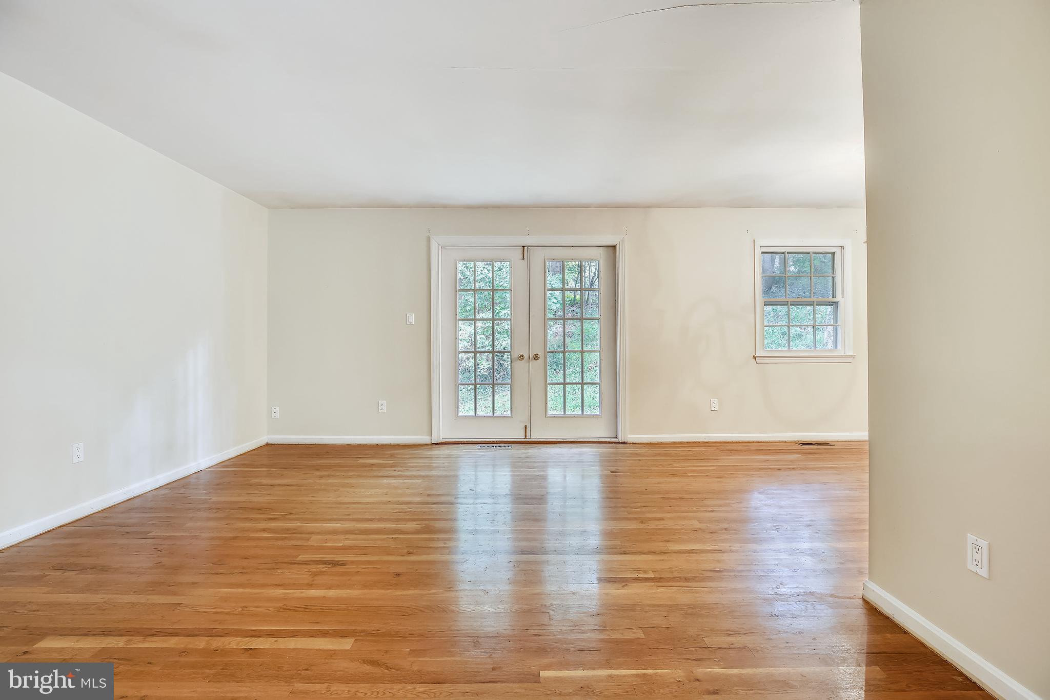 9505 Emory Grove Road Gaithersburg, MD 20877 - Photo 15 of 75 a view of an empty room with wooden floor and a window