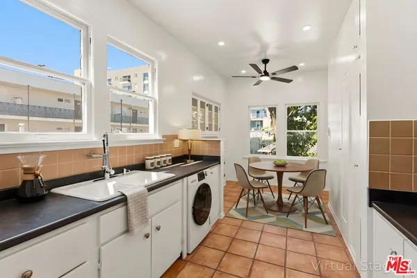 a kitchen with stainless steel appliances a sink stove and microwave
