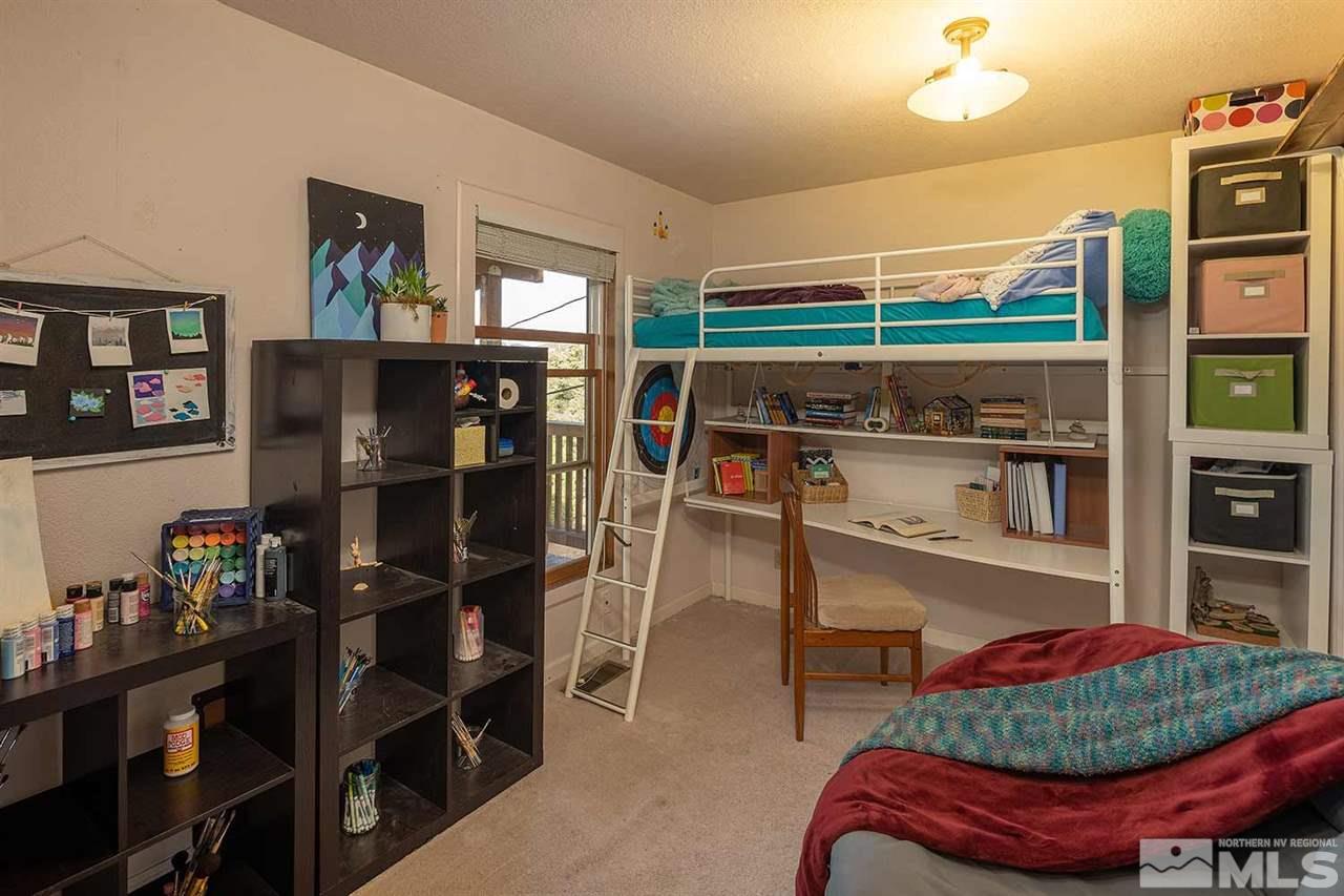 21861 Bowie Road Reno, NV 89521 - Photo 12 of 25 a room with lots of books and a large mirror