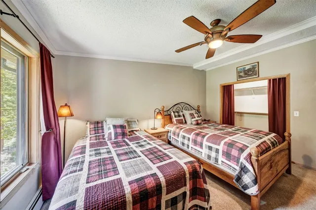 a bedroom with two beds and a large window