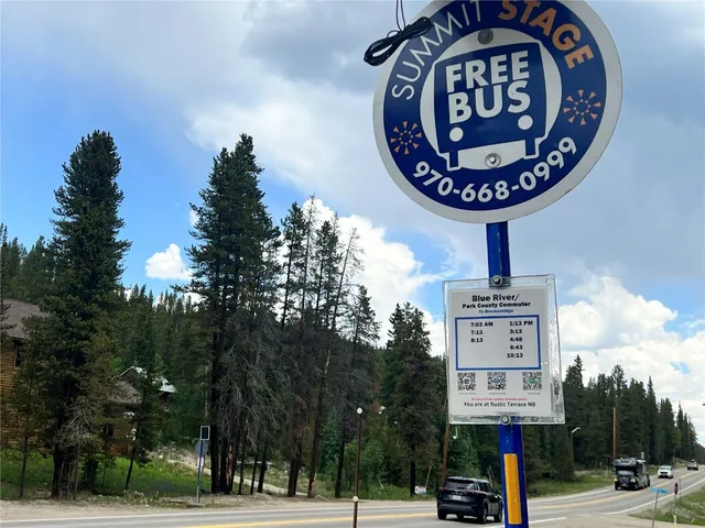 a sign board with a tree in the background