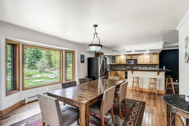 a dining room with furniture and wooden floor