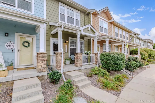 a view of house with garden and tall trees