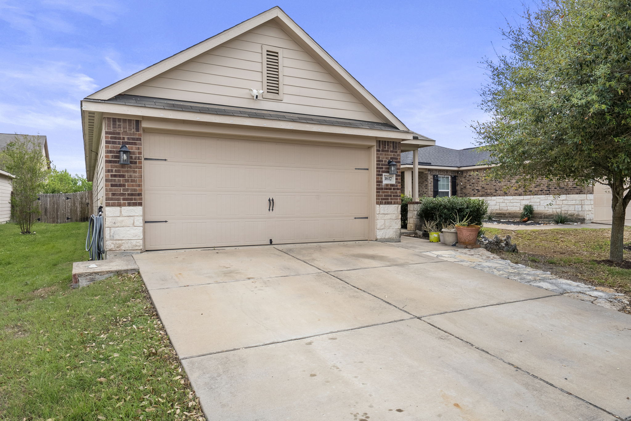 1617 Treeta Trail Kyle, TX 78640 - Photo 38 of 39 Single story home with brick siding, driveway, and a garage