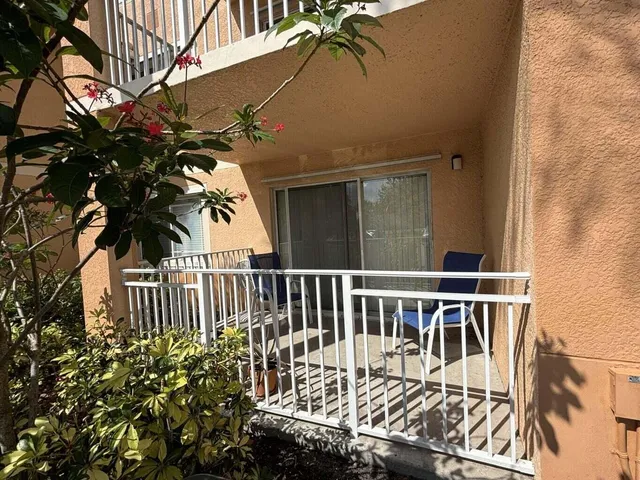 a view of a chair and table in the balcony