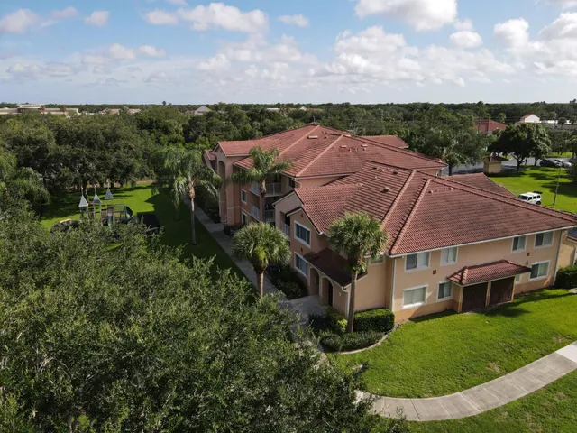 an aerial view of multiple houses with a yard