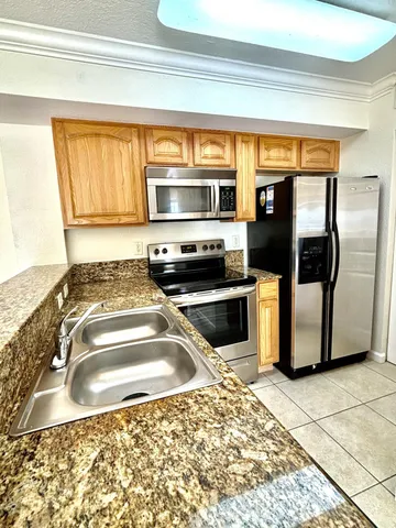 a kitchen with a sink cabinets and stainless steel appliances