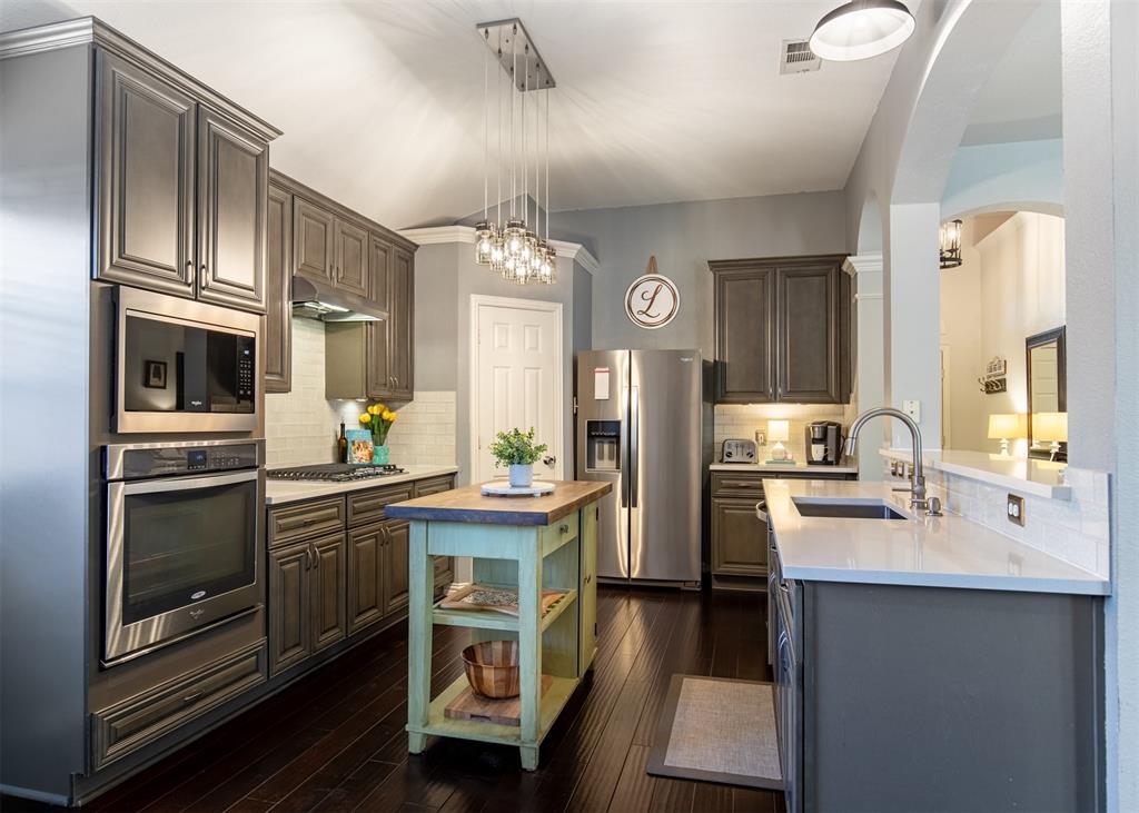 6425 Radslow Drive Frisco, TX 75035 - Photo 12 of 34 Kitchen with Whirlpool stainless steel appliances and pantry.