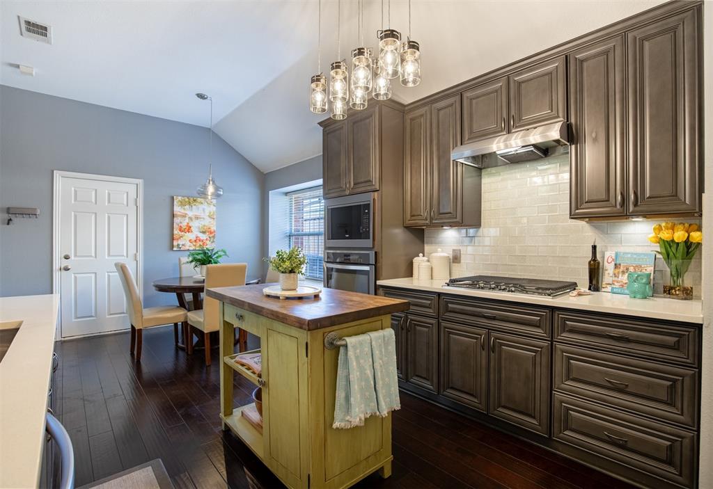 6425 Radslow Drive Frisco, TX 75035 - Photo 14 of 34 Kitchen features warm custom wood cabinetry with under-cabinet lighting.