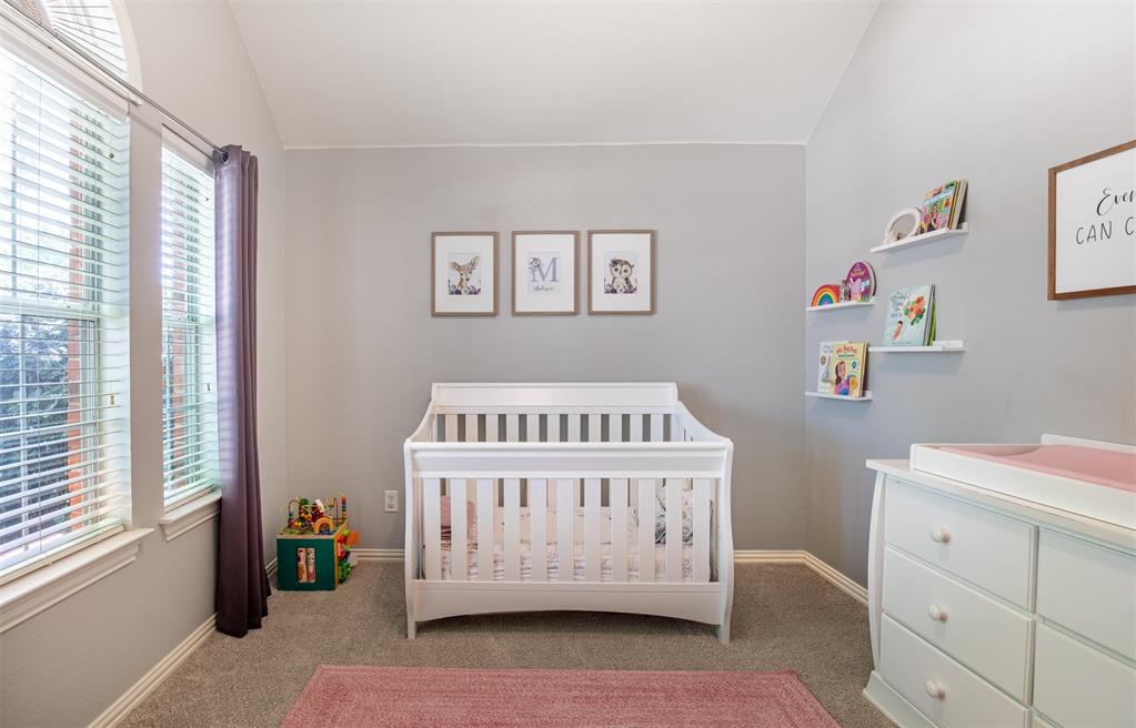 6425 Radslow Drive Frisco, TX 75035 - Photo 25 of 34 Secondary bedroom with sloped ceiling and soft paint.