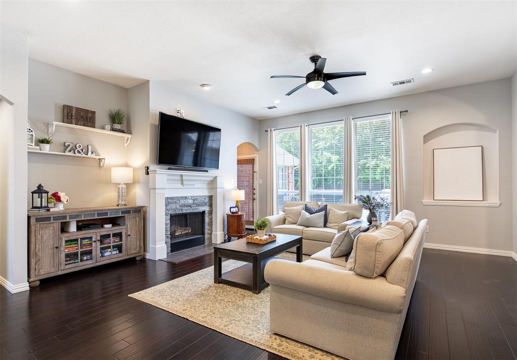 6425 Radslow Drive Frisco, TX 75035 - Photo 6 of 34 Spacious living room anchored by a fireplace.