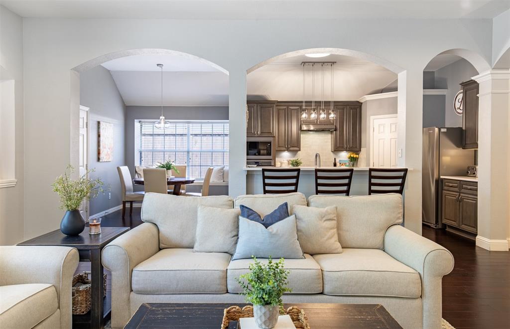 6425 Radslow Drive Frisco, TX 75035 - Photo 8 of 34 Living room flows seamlessly to breakfast room and kitchen.