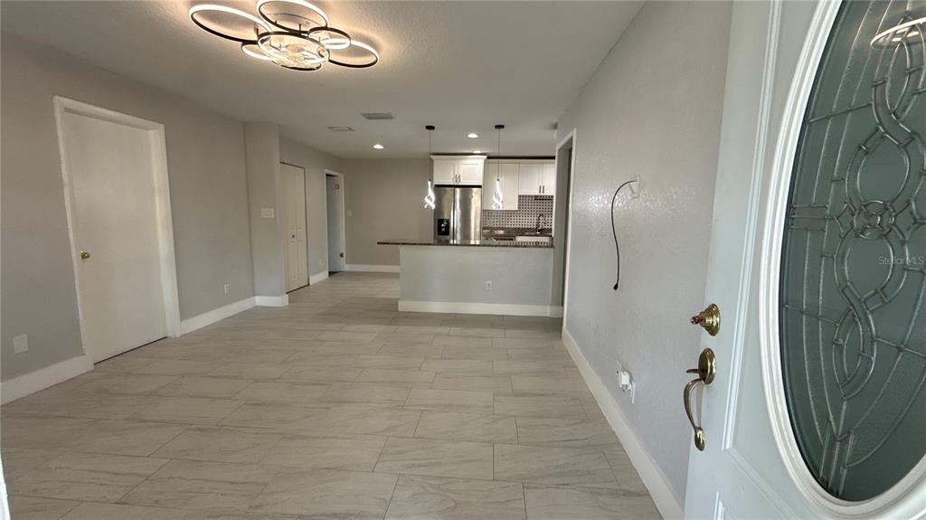 8106 Wichita Way Tampa, FL 33619 - Photo 2 of 21 a view of a hallway with wooden floor and entryway
