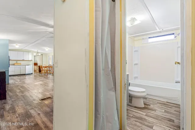 a bathroom with a toilet tub and a shower