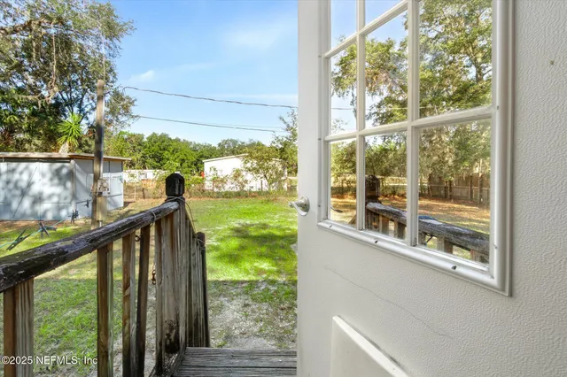 a view of a house with yard and sitting area