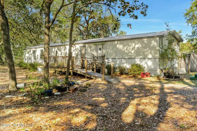 a view of dirt field with trees