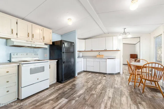a kitchen with white cabinets and white appliances
