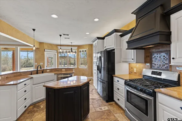 a kitchen with a sink stove and refrigerator