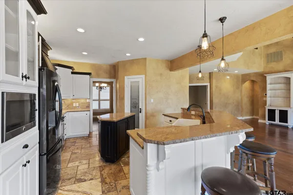 a kitchen with a sink appliances and cabinets