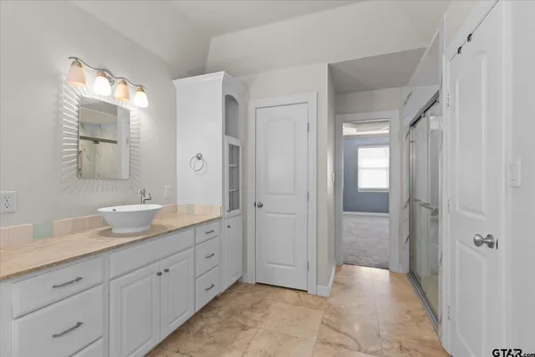 a bathroom with a sink a toilet and a mirror