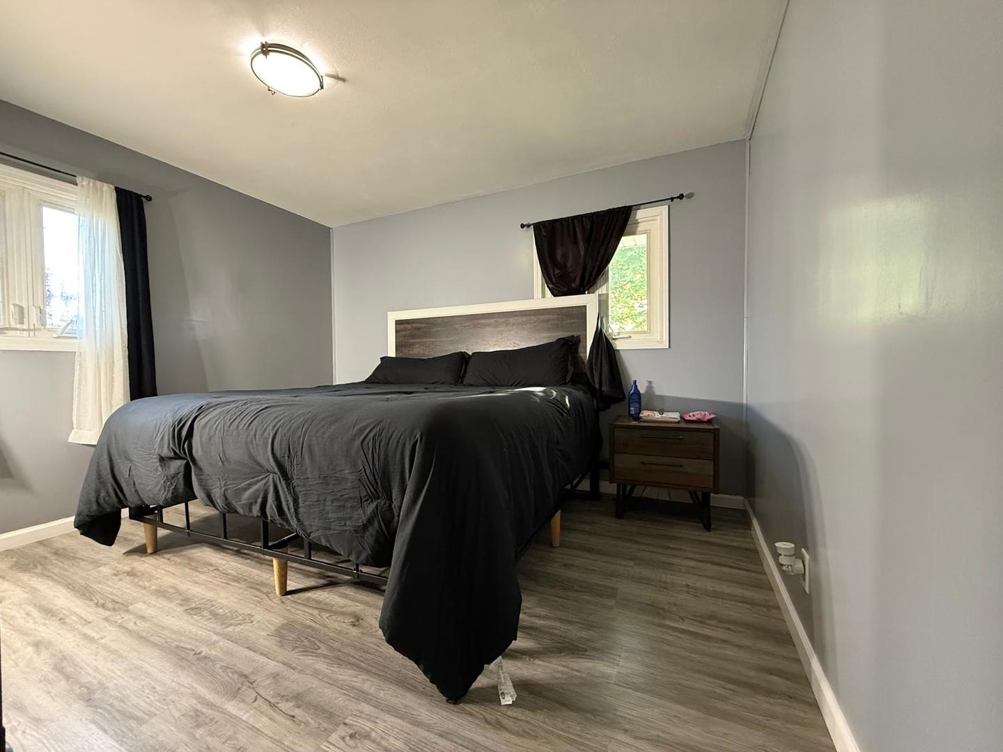 424 Rambler Place Streamwood, IL 60107 - Photo 6 of 10 a bedroom with a bed and wooden floor
